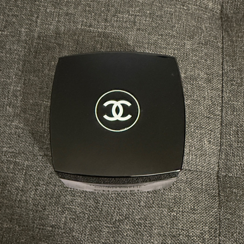 Empty CHANEL moisturizer container.